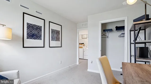 a view of a livingroom with furniture and an empty room