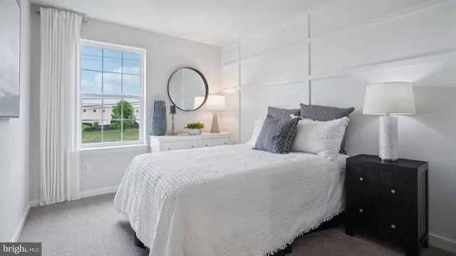 a bedroom with a large bed and a window