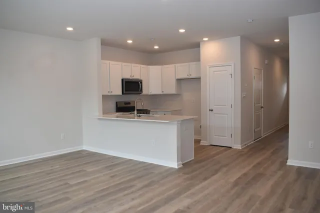 a kitchen with a refrigerator and a stove top oven