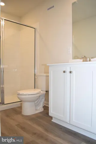 a bathroom with a toilet and a shower