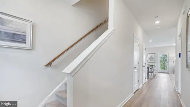 a view of hallway with wooden floor