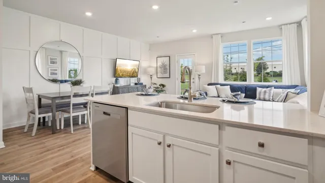 a kitchen with stainless steel appliances a sink a stove window and cabinets