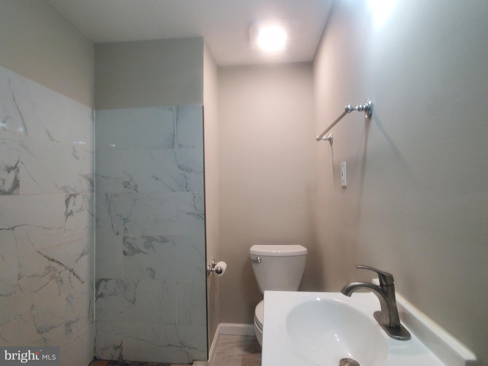 14813 Hammersmith Circle Silver Spring, MD 20906 - Photo 15 of 36 a white toilet sitting next to a bathroom sink