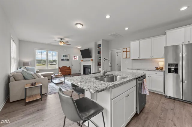 a kitchen with a table chairs refrigerator and microwave