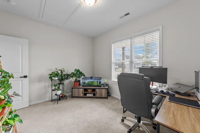 a view of a workspace with furniture and a window