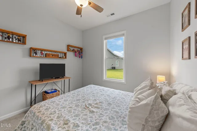 a bedroom with a bed and a desk