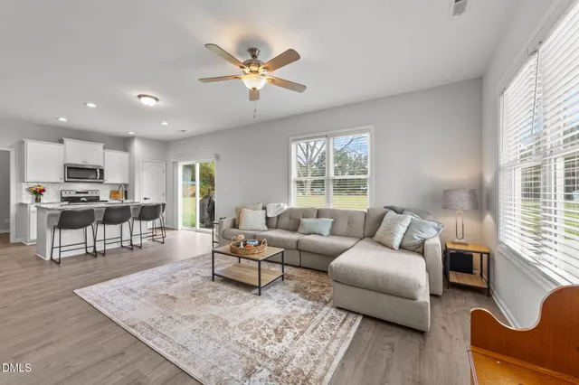a living room with furniture and wooden floor