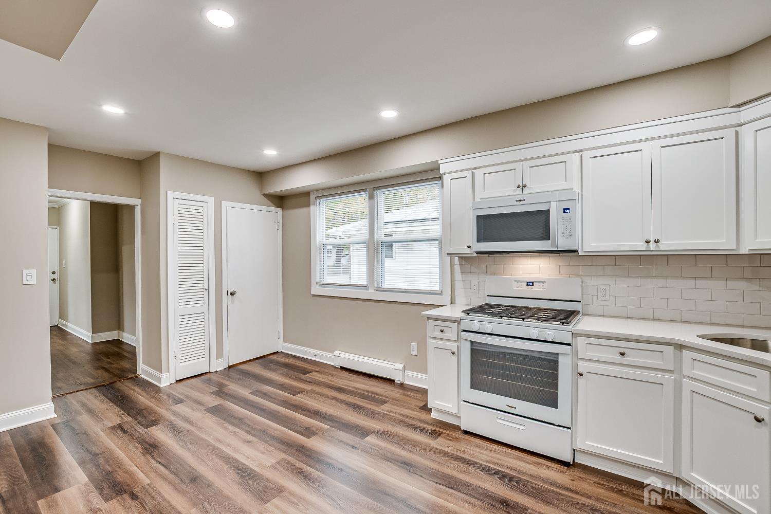 93 Player Avenue Edison, NJ 08817 - Photo 11 of 29 a kitchen with granite countertop a stove a sink and a refrigerator
