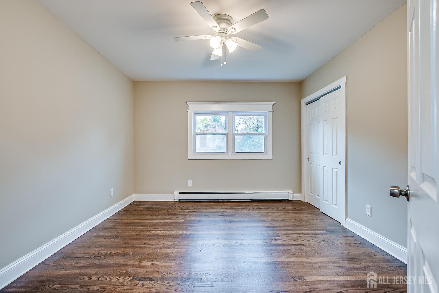 93 Player Avenue Edison, NJ 08817 - Photo 14 of 29 wooden floor in an empty room with a window