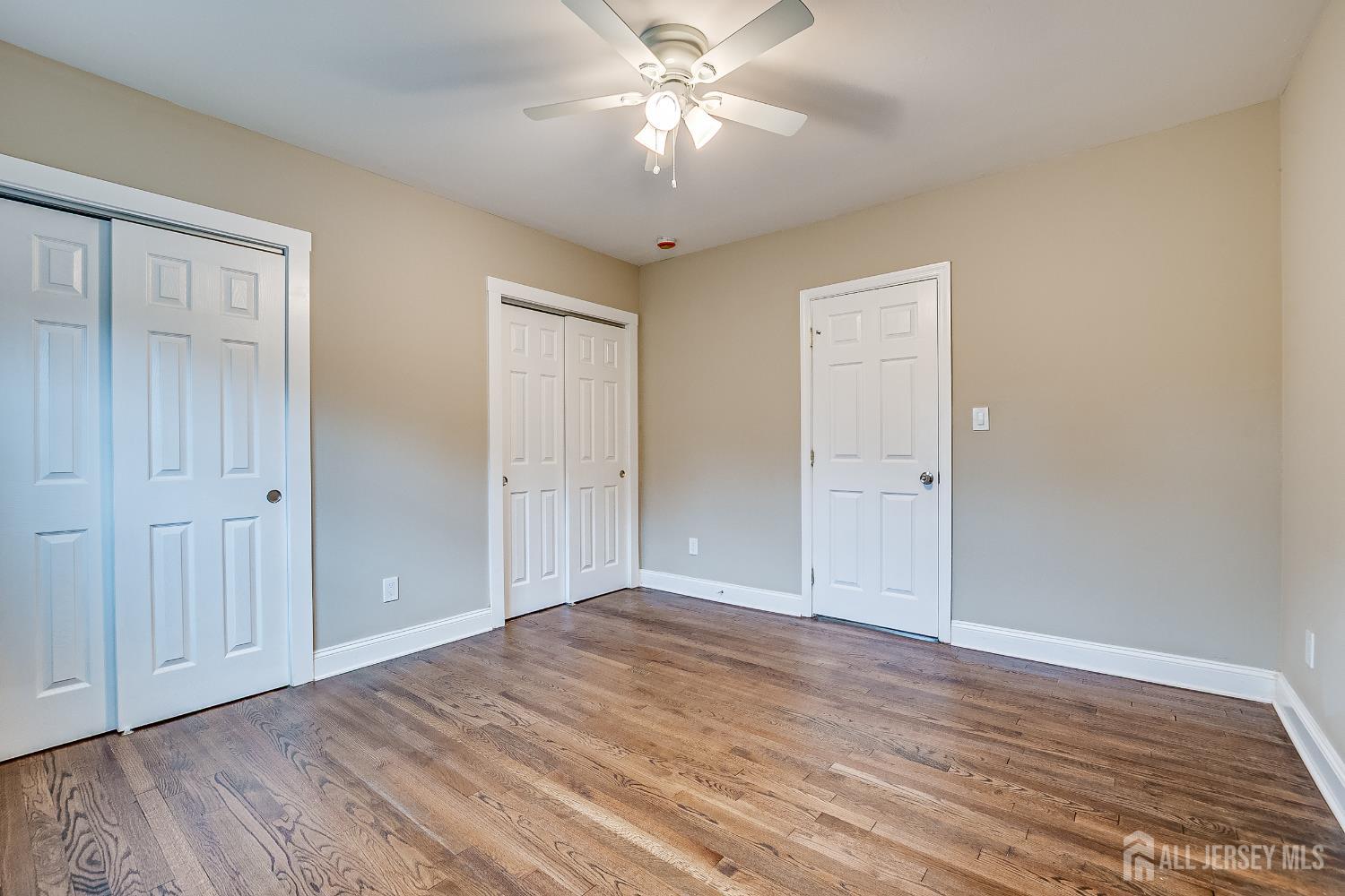 93 Player Avenue Edison, NJ 08817 - Photo 15 of 29 a view of a room with wooden floor and a ceiling fan