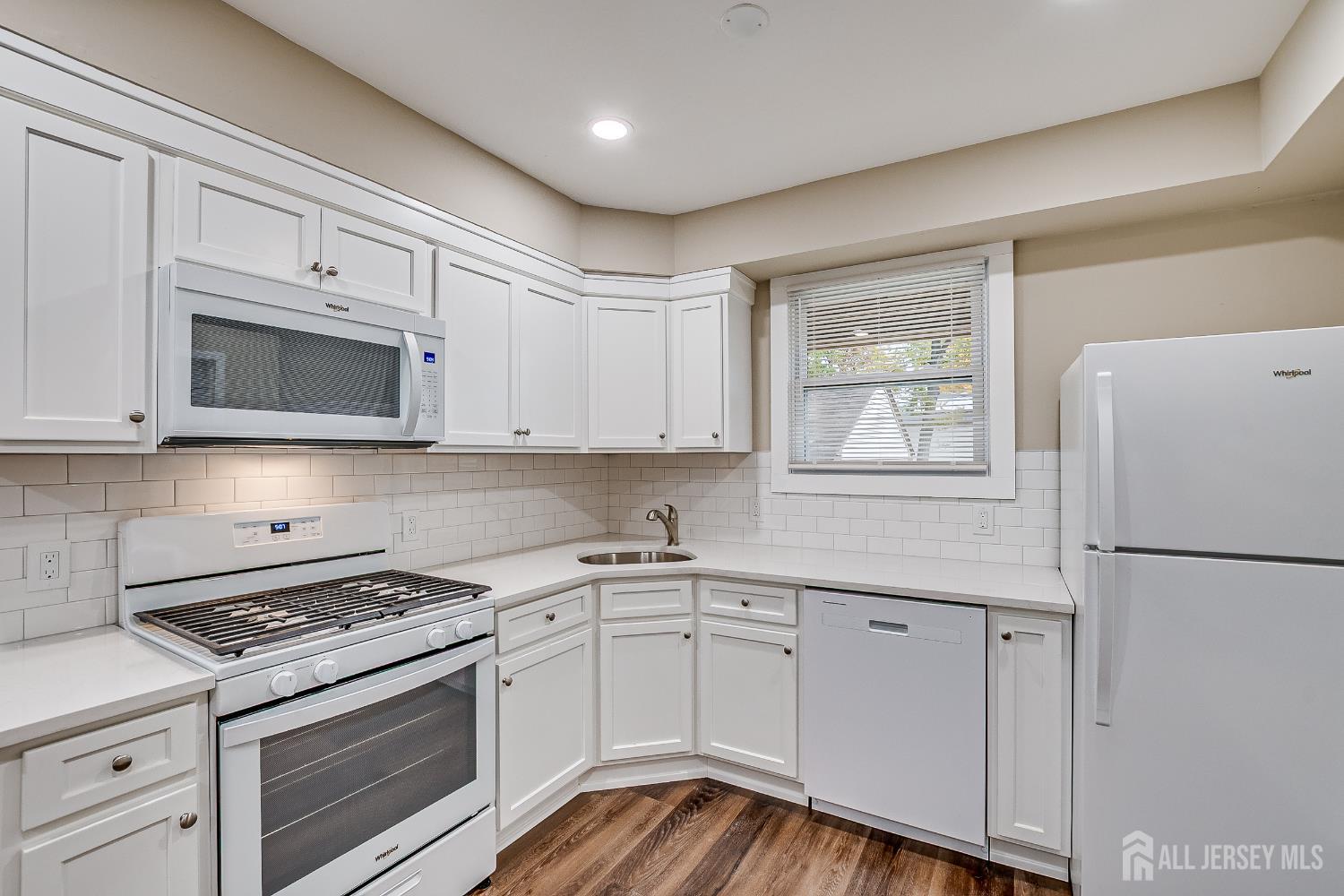 93 Player Avenue Edison, NJ 08817 - Photo 2 of 29 a kitchen with white cabinets and white appliances