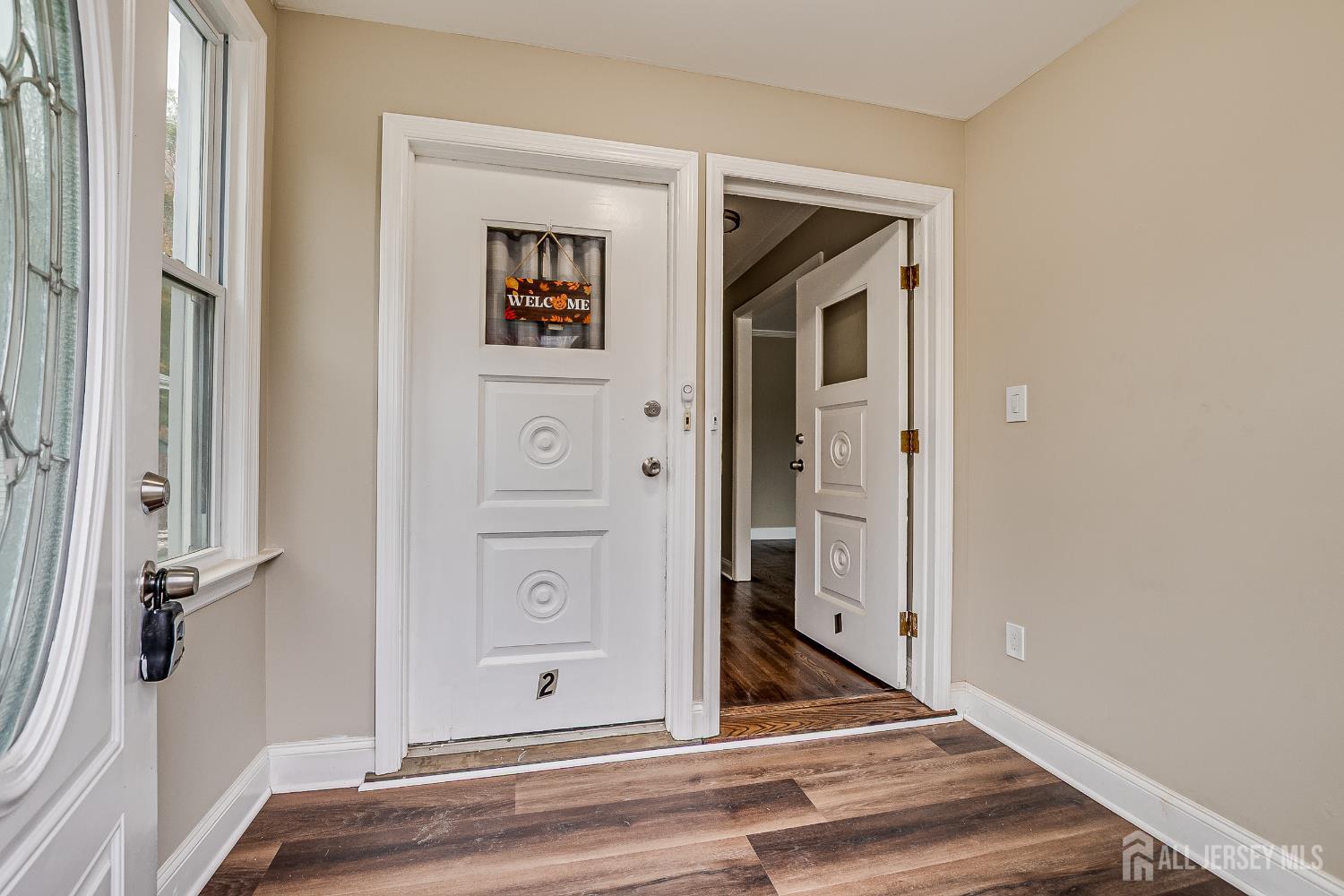 93 Player Avenue Edison, NJ 08817 - Photo 4 of 29 a view of a hallway with wooden floor and closet