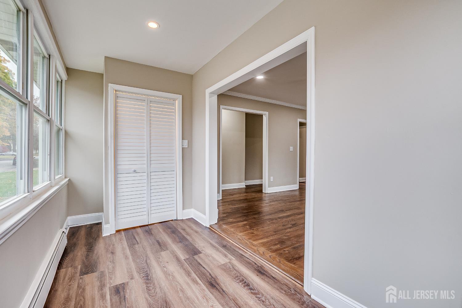 93 Player Avenue Edison, NJ 08817 - Photo 8 of 29 an empty room with wooden floor and windows