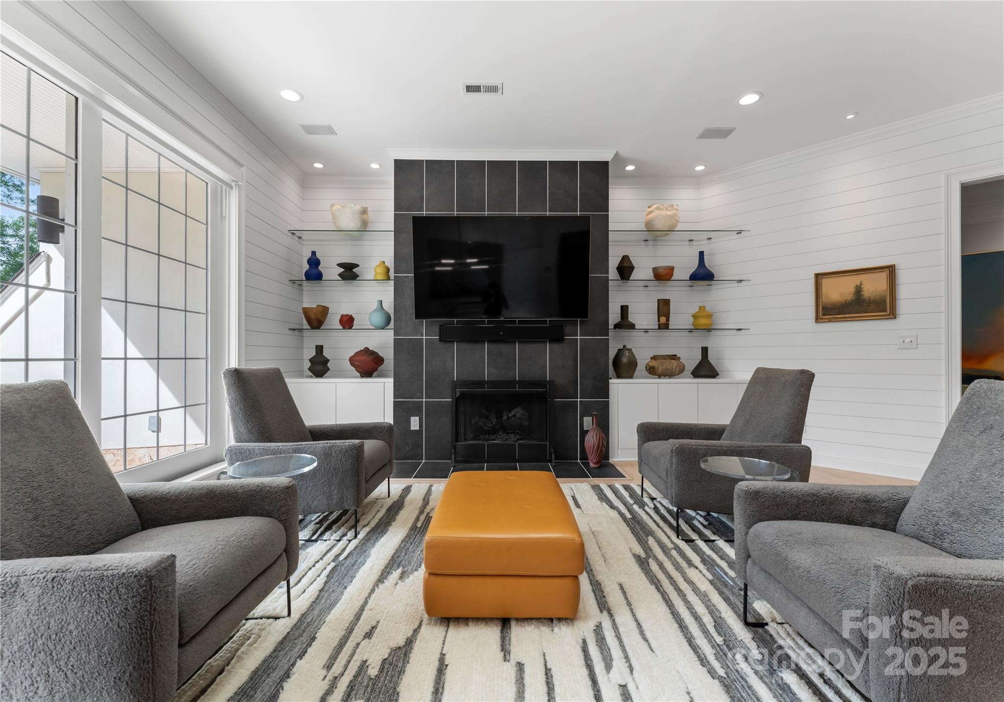 974 Queens Road Charlotte, NC 28207 - Photo 7 of 26 a living room with furniture a flat screen tv and a fireplace