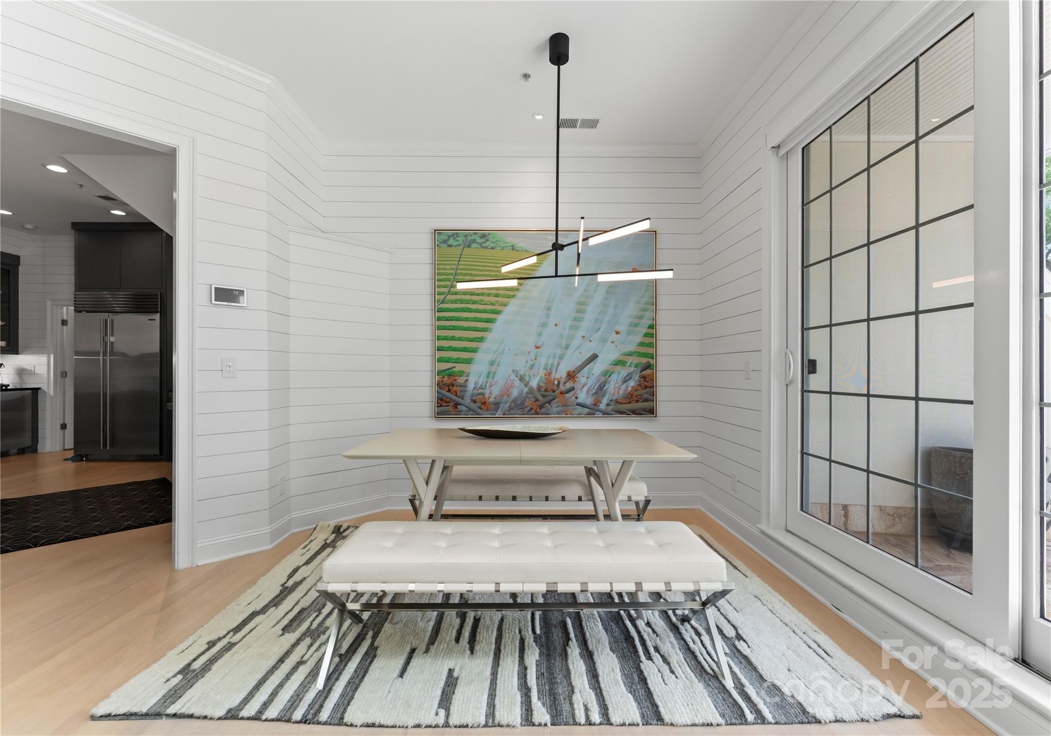 974 Queens Road Charlotte, NC 28207 - Photo 9 of 26 a view of a room with wooden floor and a rug
