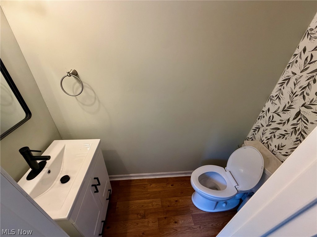 37373 Butternut Ridge Road North Ridgeville, OH 44039 - Photo 12 of 22 White vanity with integrated sink, matte black faucet, and wood-finish flooring