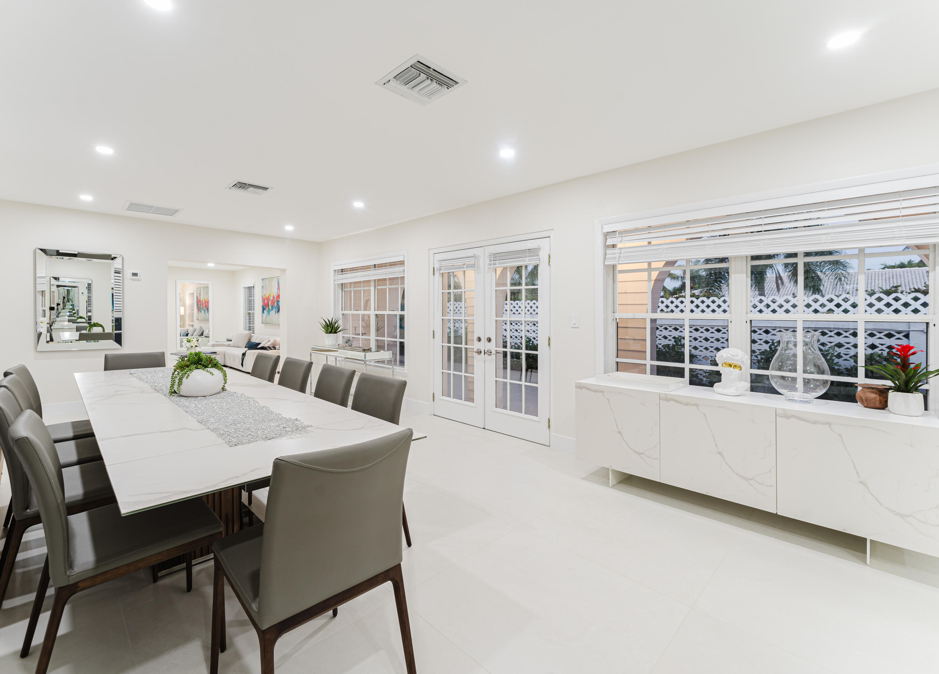 3199 Northeast 6th Drive Boca Raton, FL 33431 - Photo 15 of 49 a large white kitchen with a table and chairs