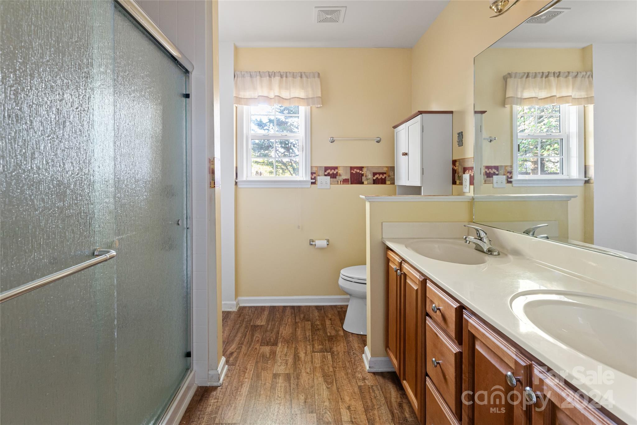 183 Lumber River Road Fletcher, NC 28732 - Photo 19 of 31 a bathroom with a sink a mirror and a bathtub
