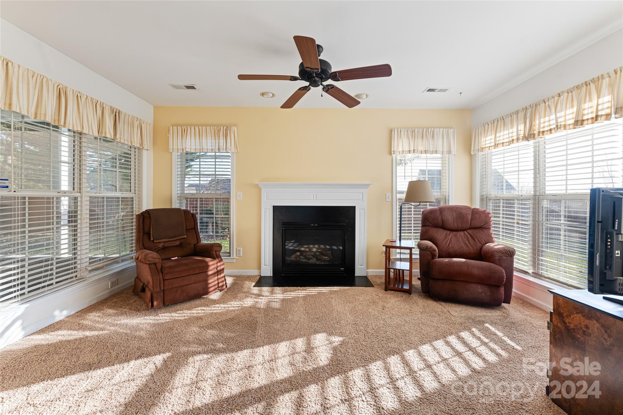 183 Lumber River Road Fletcher, NC 28732 - Photo 8 of 31 a living room with furniture a fireplace and a large window