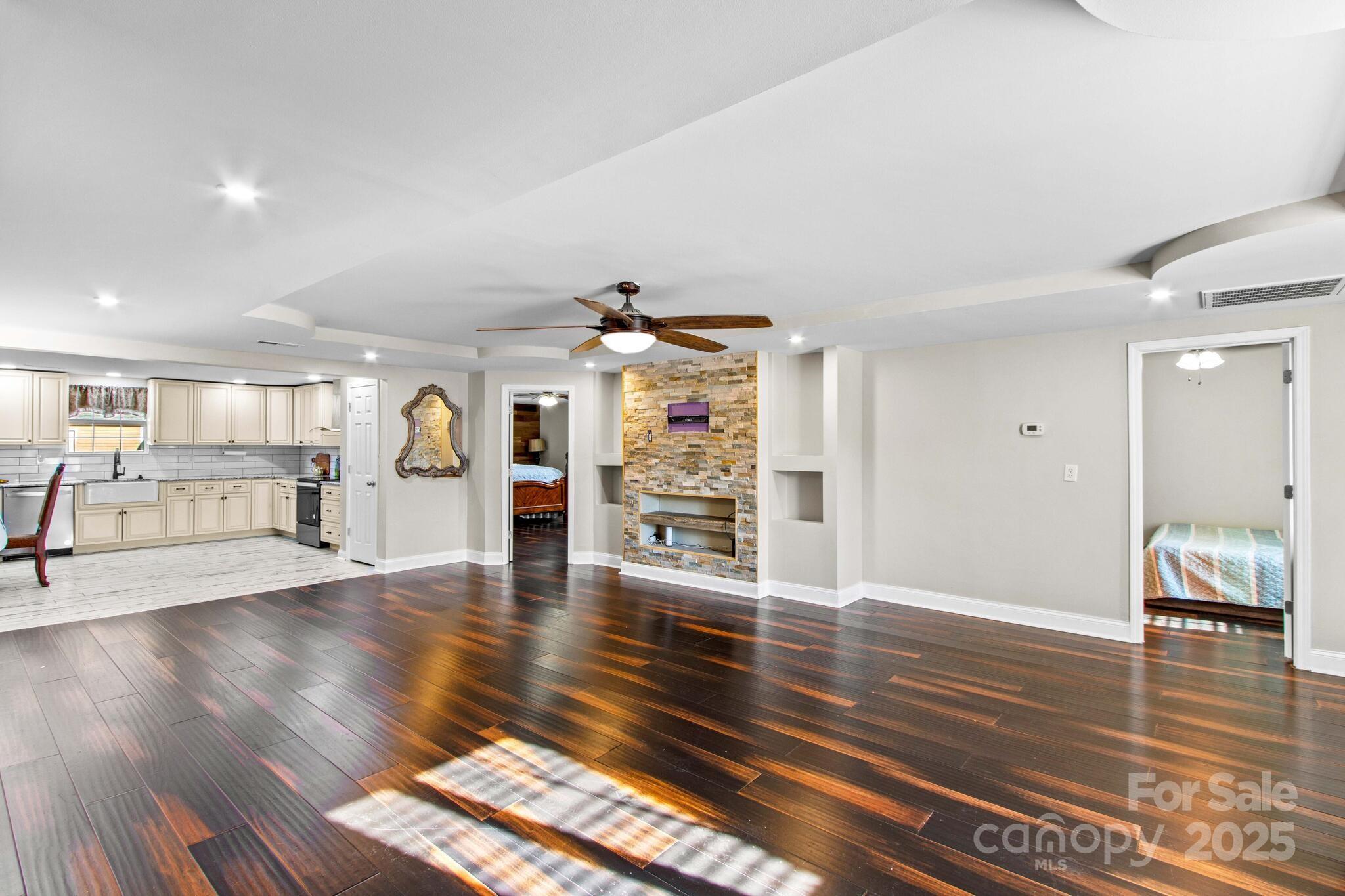 1493 Swicegood Road Linwood, NC 27299 - Photo 11 of 45 a living room with furniture and wooden floor