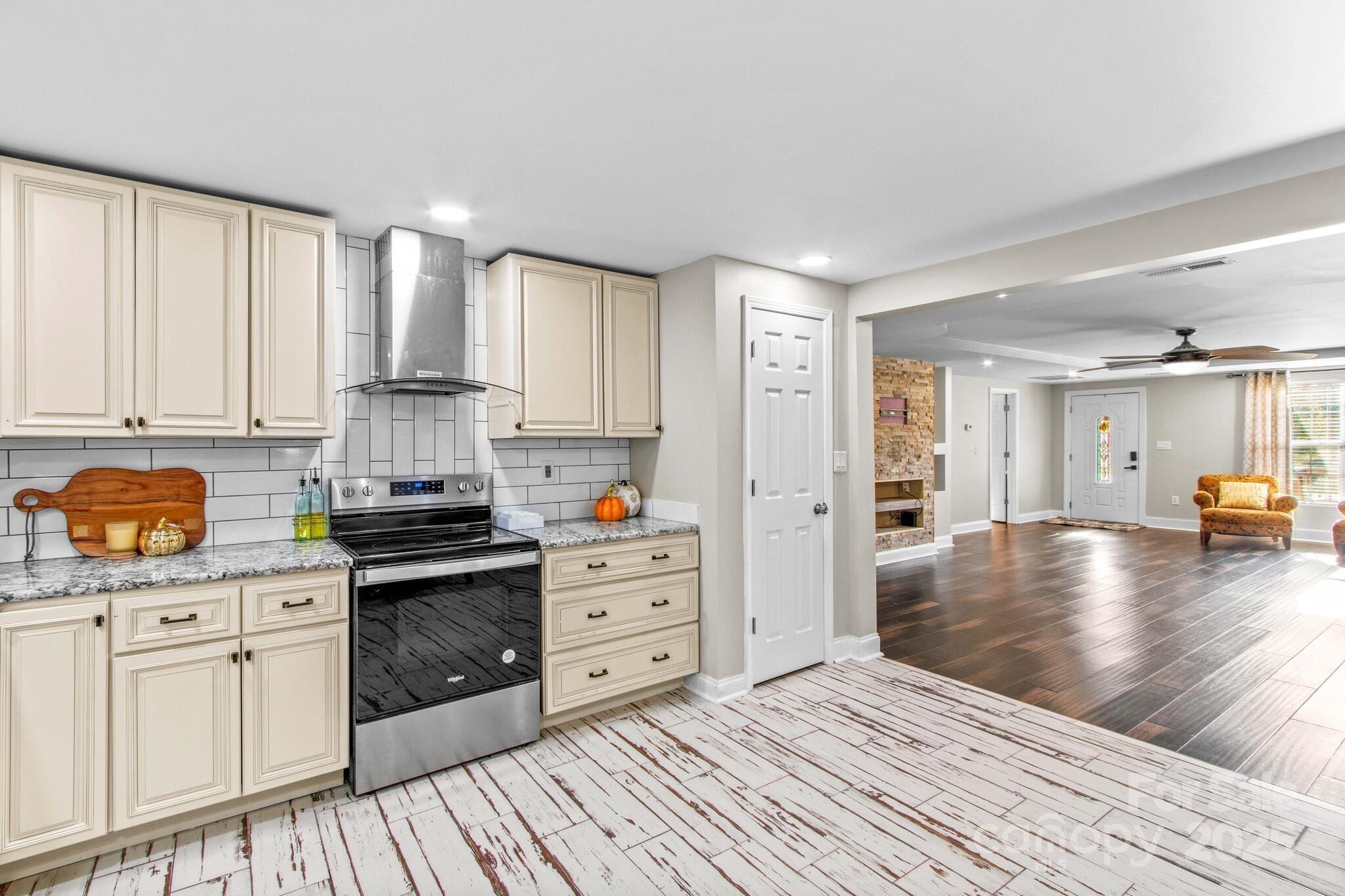 1493 Swicegood Road Linwood, NC 27299 - Photo 17 of 45 a kitchen with stainless steel appliances a refrigerator sink and cabinets