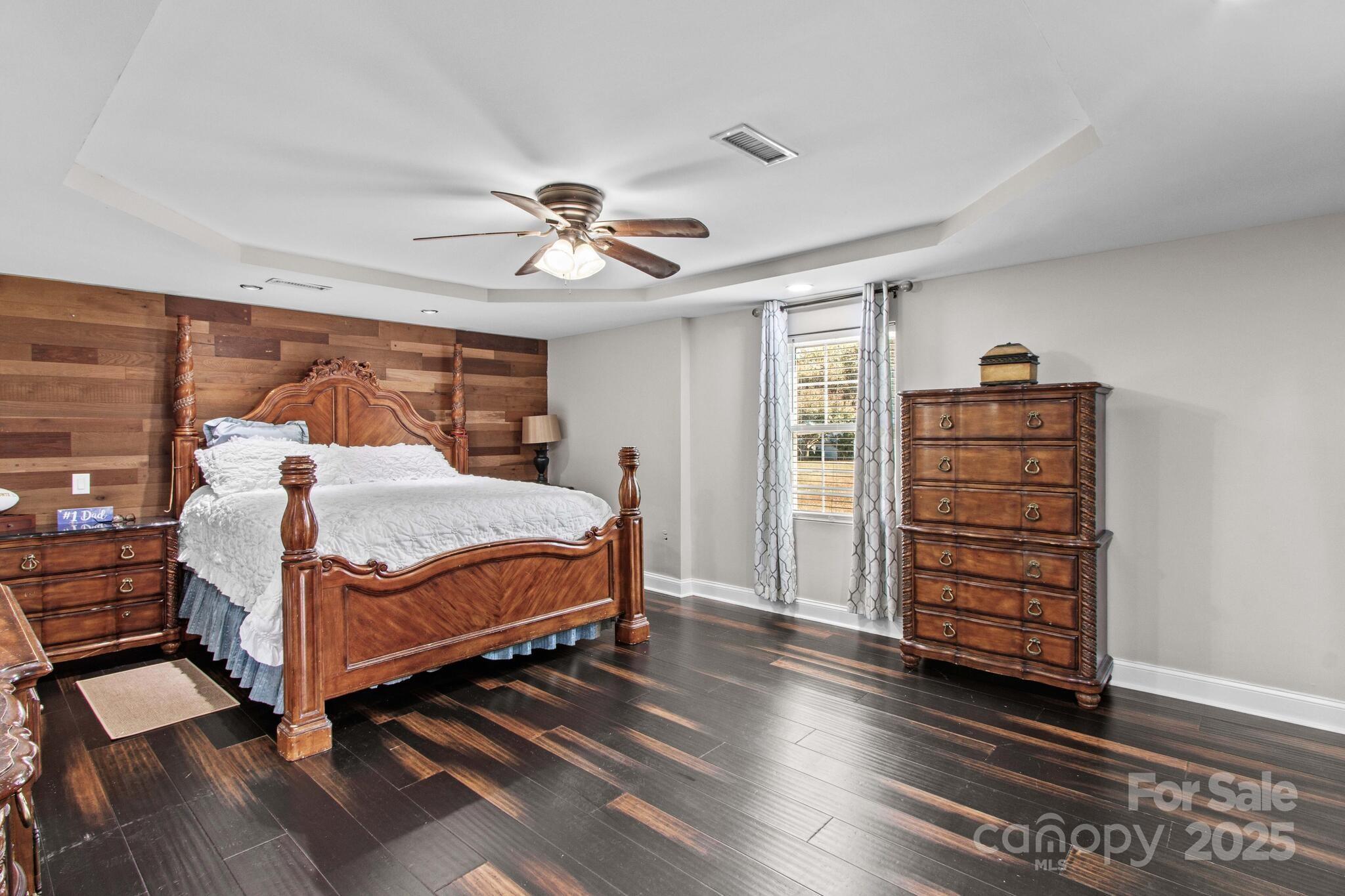 1493 Swicegood Road Linwood, NC 27299 - Photo 18 of 45 a bedroom with a bed and wooden floor