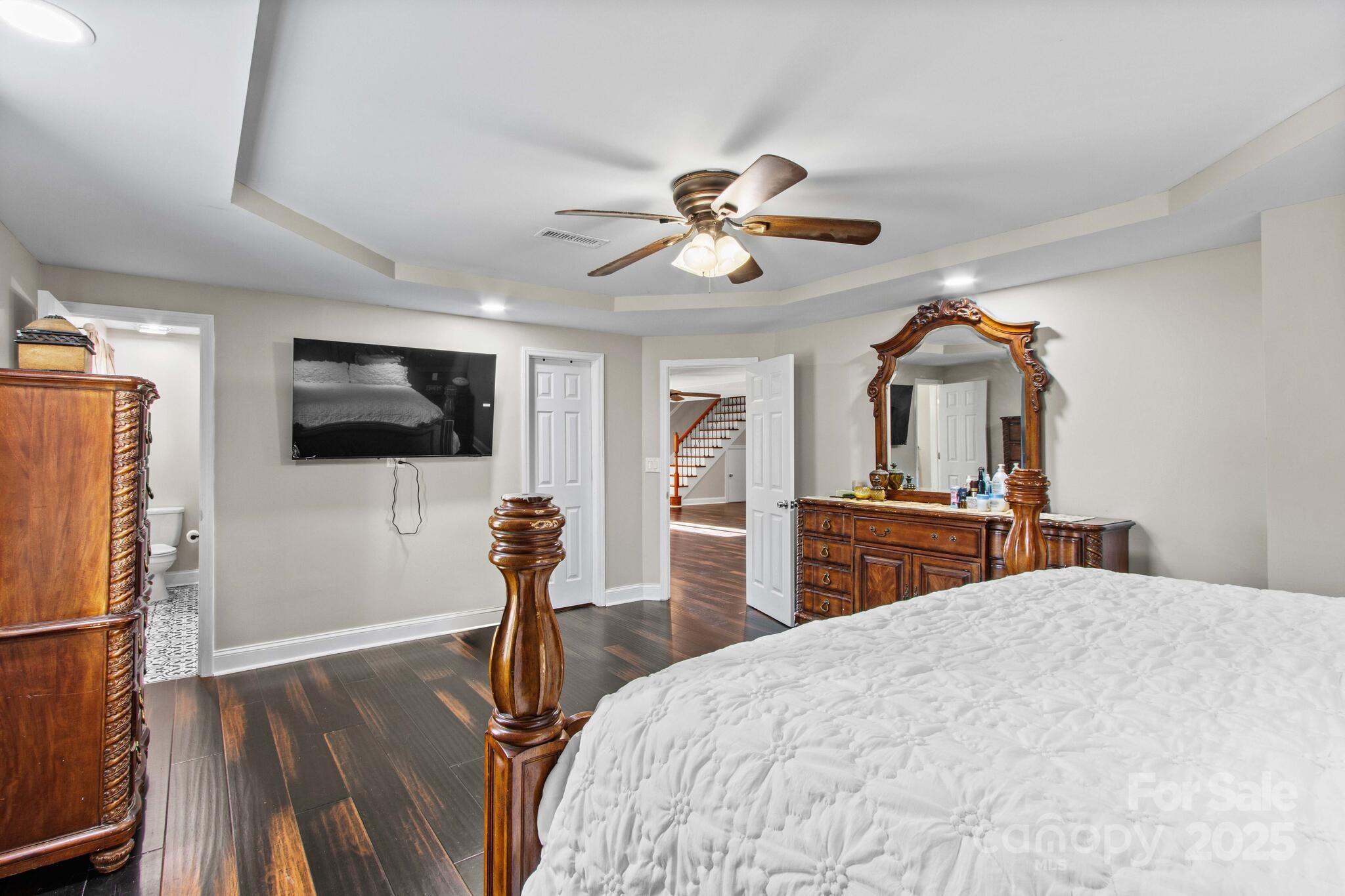 1493 Swicegood Road Linwood, NC 27299 - Photo 19 of 45 a bedroom with a bed and a flat screen tv