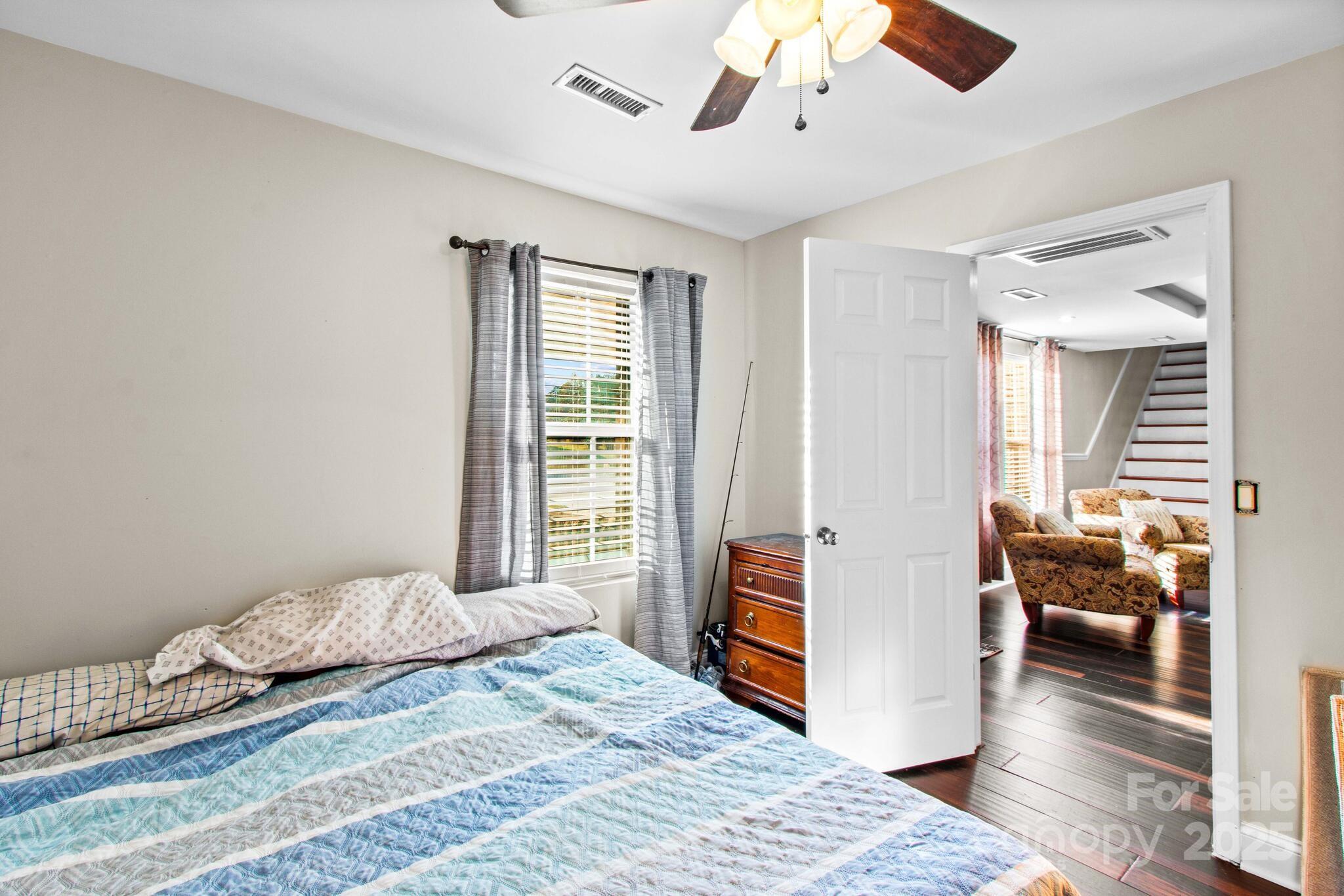 1493 Swicegood Road Linwood, NC 27299 - Photo 22 of 45 a bedroom with a bed and wooden floor