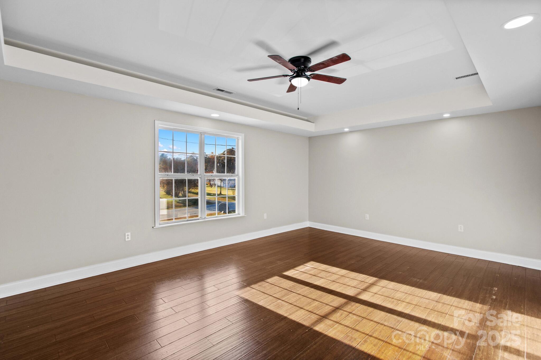 1493 Swicegood Road Linwood, NC 27299 - Photo 24 of 45 a view of wooden floor and windows in a room