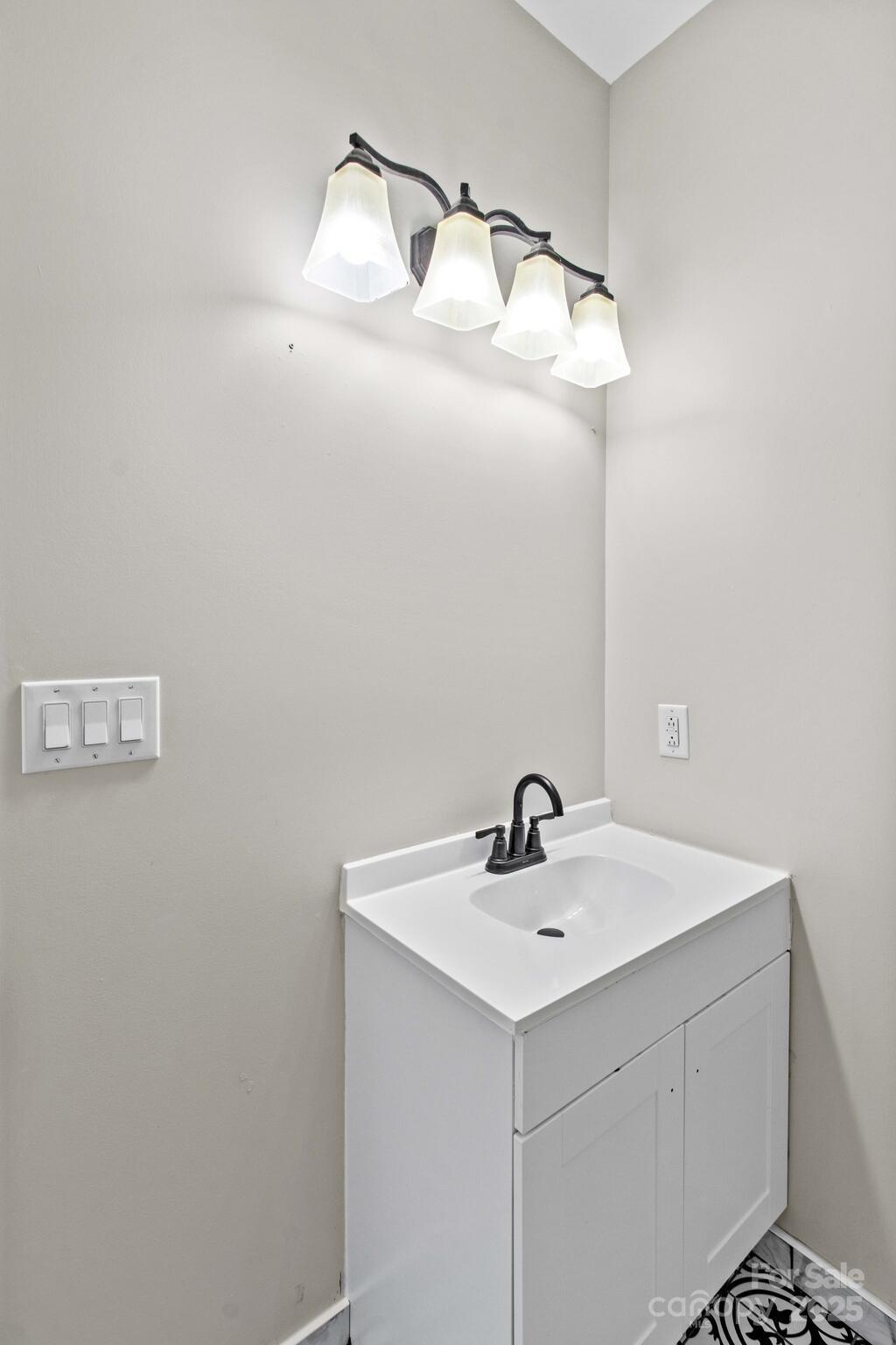 1493 Swicegood Road Linwood, NC 27299 - Photo 26 of 45 a bathroom with a sink and mirror