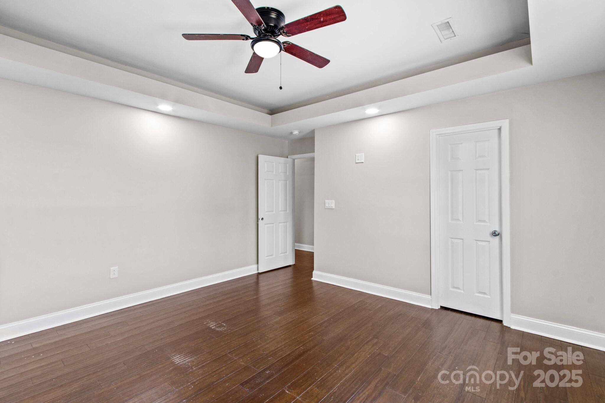 1493 Swicegood Road Linwood, NC 27299 - Photo 29 of 45 a view of a big room with wooden floor and windows