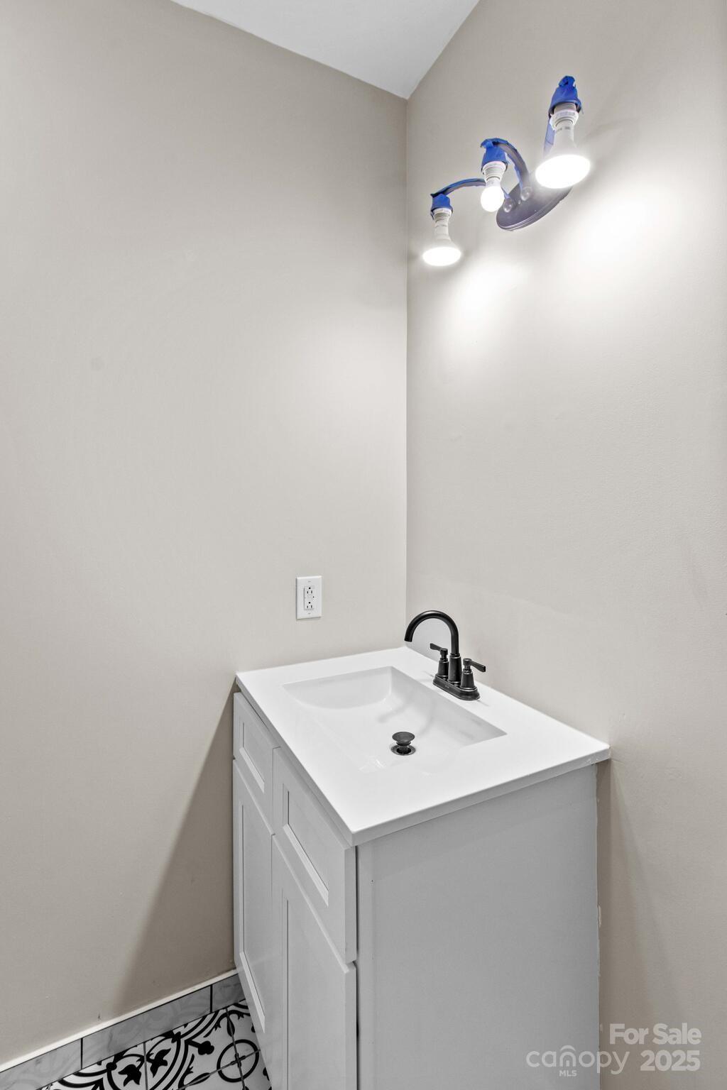 1493 Swicegood Road Linwood, NC 27299 - Photo 30 of 45 a bathroom with a sink vanity and a mirror