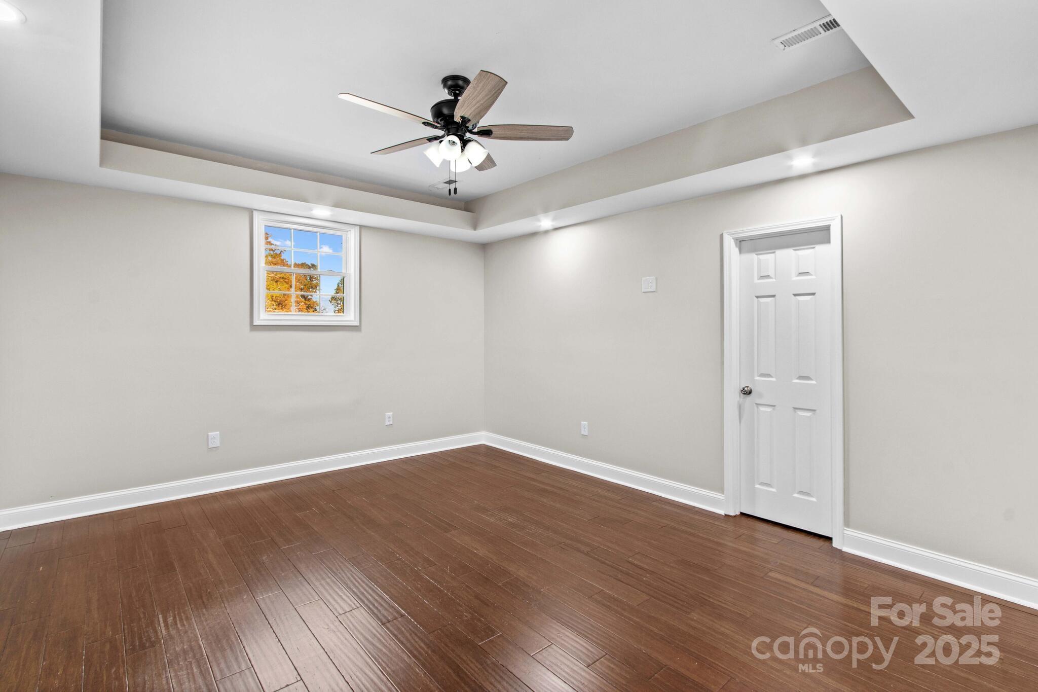 1493 Swicegood Road Linwood, NC 27299 - Photo 32 of 45 a view of empty room with wooden floor