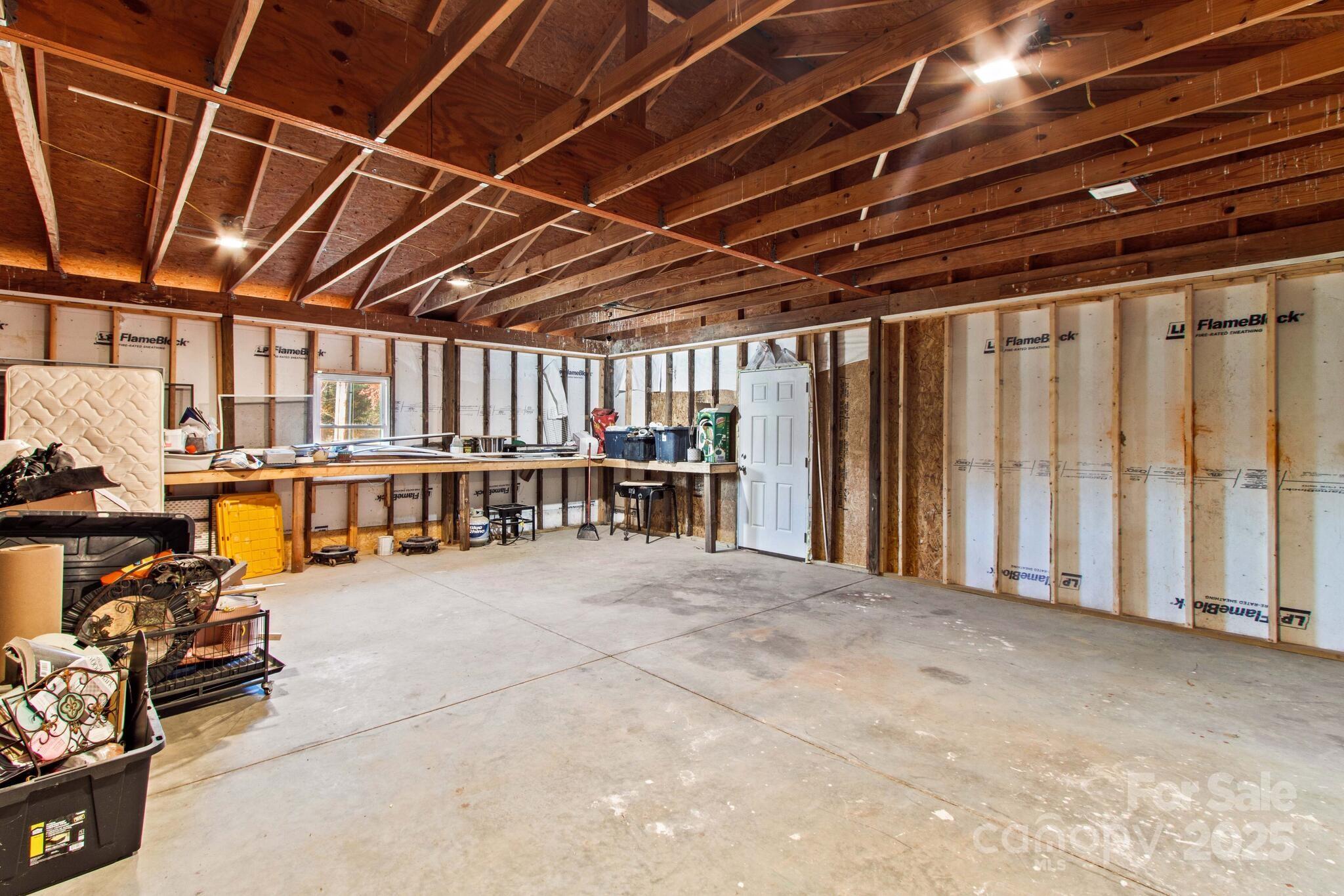 1493 Swicegood Road Linwood, NC 27299 - Photo 35 of 45 a view of an empty room with wooden walls