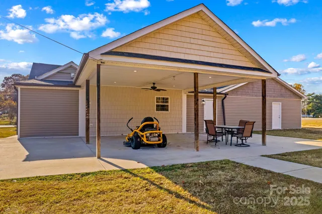 a view of a house with pool and chairs