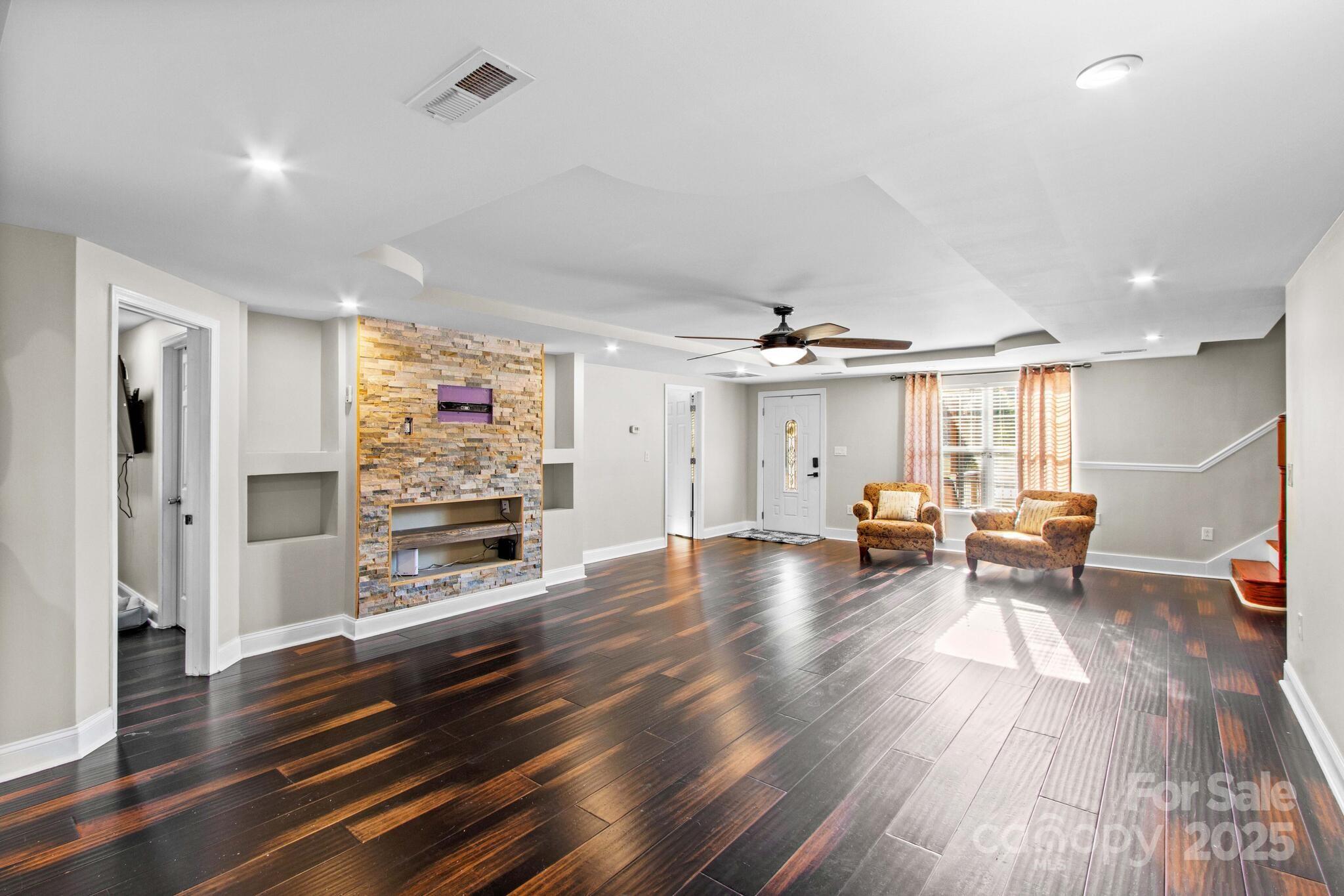 1493 Swicegood Road Linwood, NC 27299 - Photo 10 of 45 a view of a living room hardwood floor and a ceiling fan