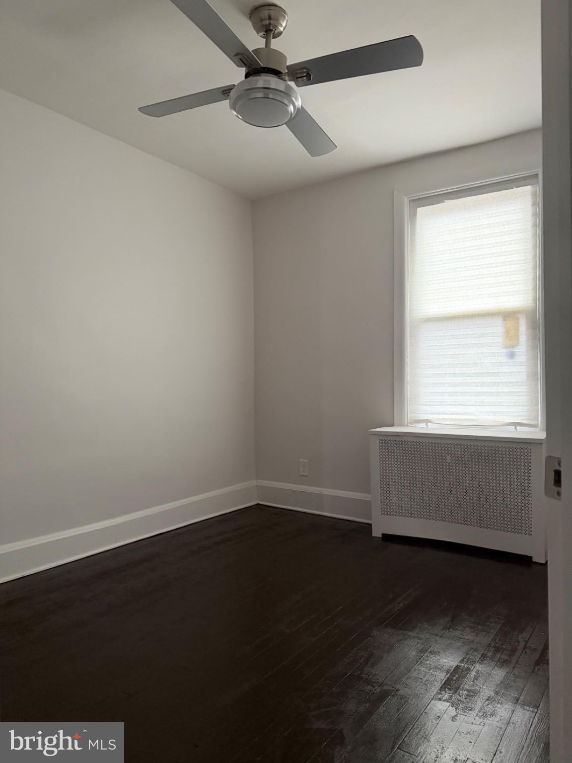 4027 Annellen Road Baltimore, MD 21215 - Photo 13 of 16 an empty room with wooden floor and windows