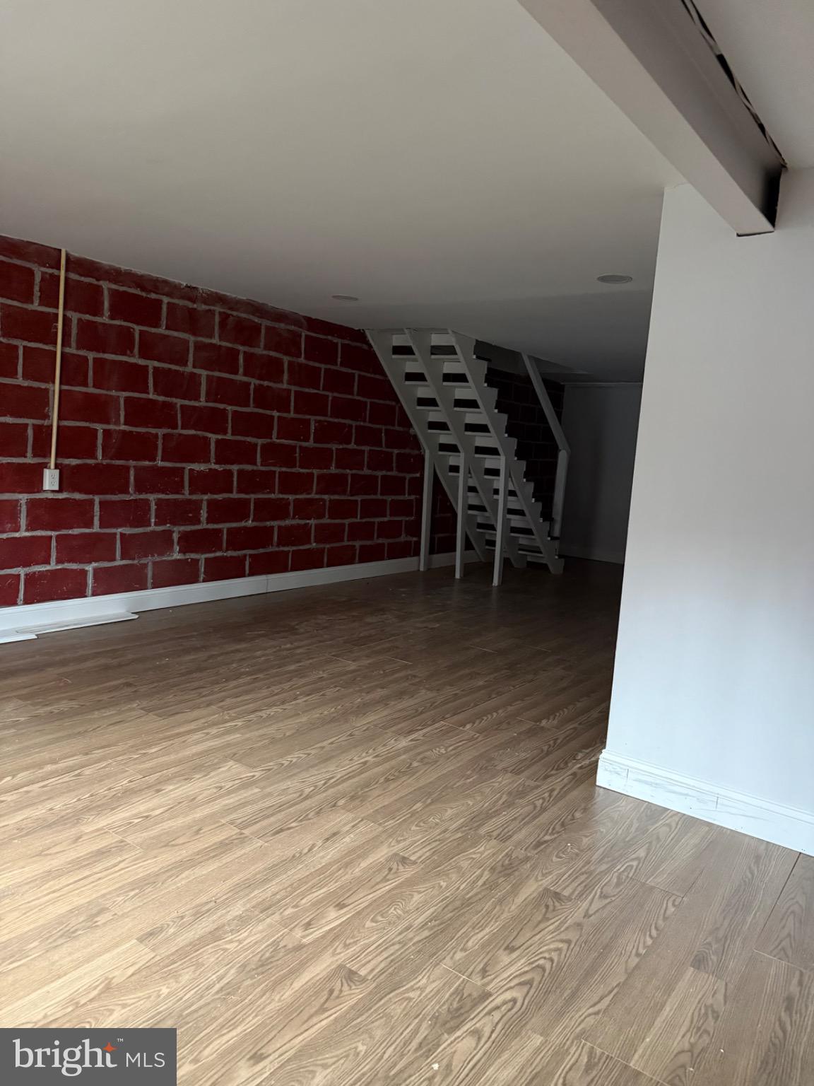 4027 Annellen Road Baltimore, MD 21215 - Photo 15 of 16 a view of an empty room with wooden floor and windows