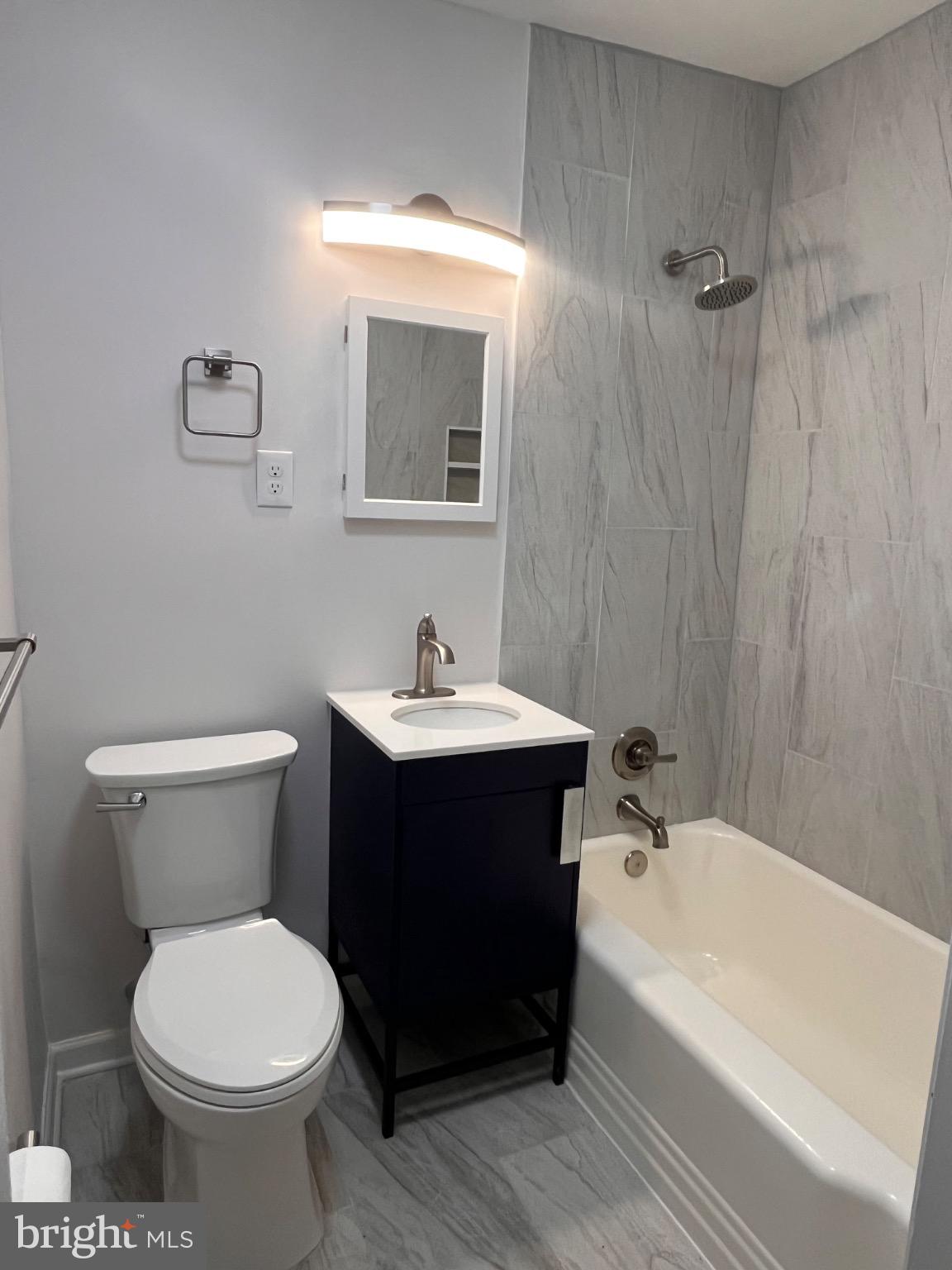 4027 Annellen Road Baltimore, MD 21215 - Photo 10 of 16 a bathroom with a toilet sink and mirror