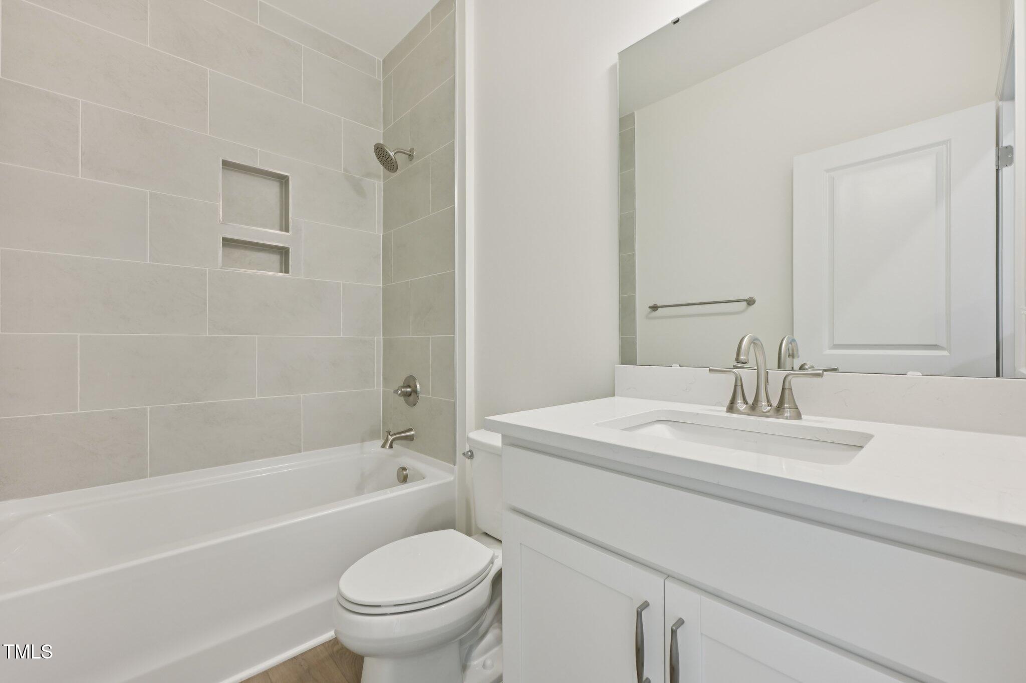 214 Alden Way Angier, NC 27501 - Photo 12 of 35 a bathroom with a sink a toilet and a bathtub