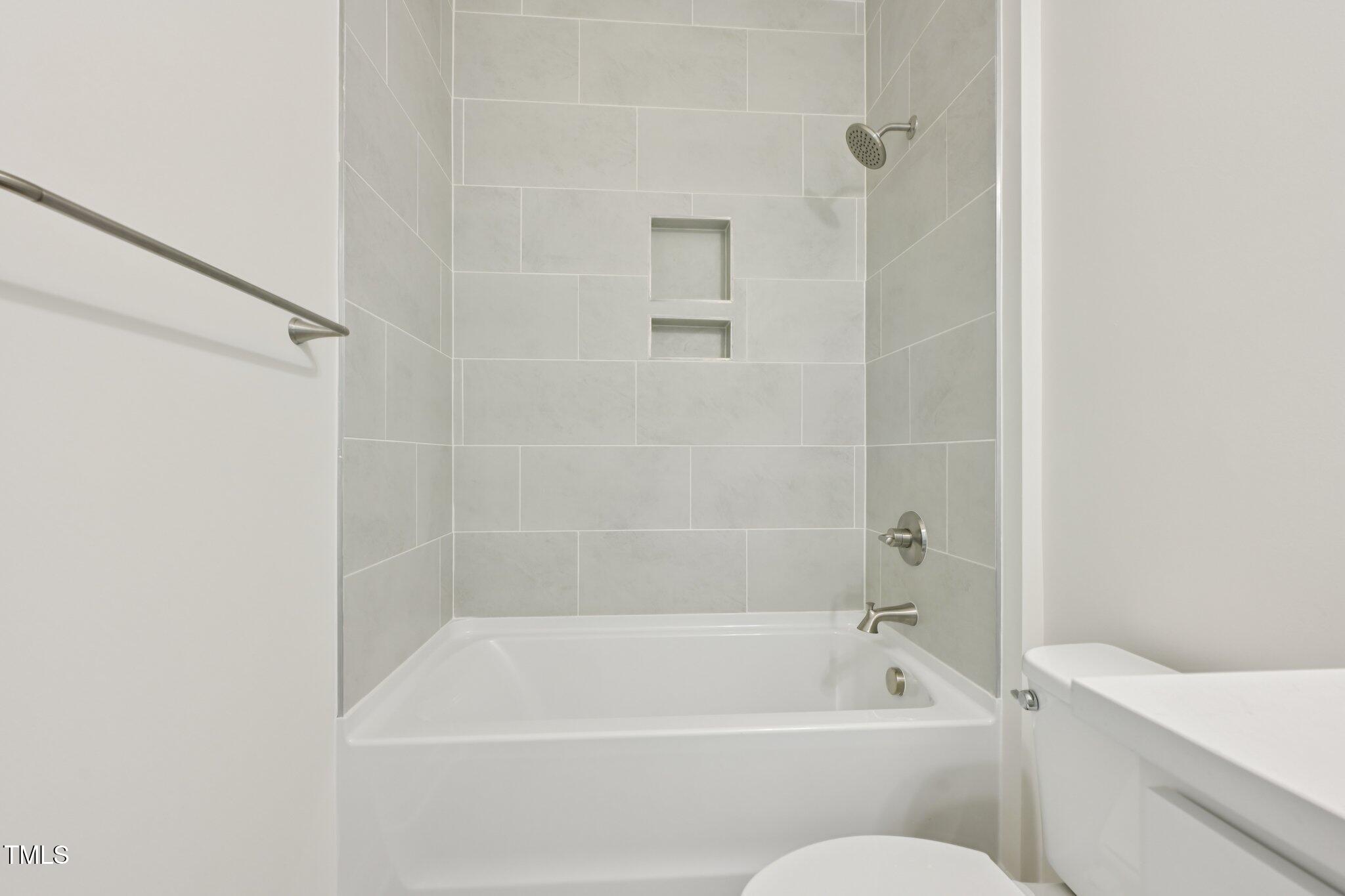 214 Alden Way Angier, NC 27501 - Photo 13 of 35 a bathroom with a shower and a bath tub