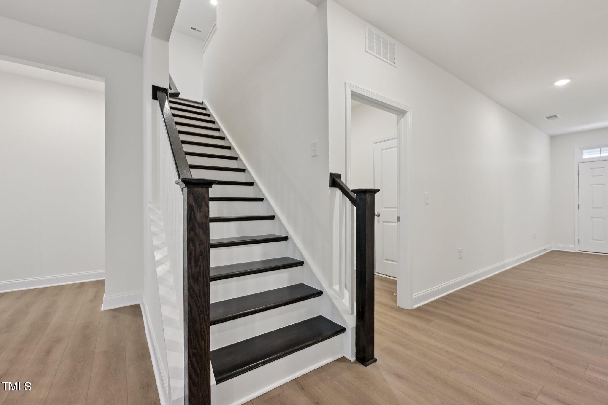 214 Alden Way Angier, NC 27501 - Photo 16 of 35 a view of entryway with wooden floor