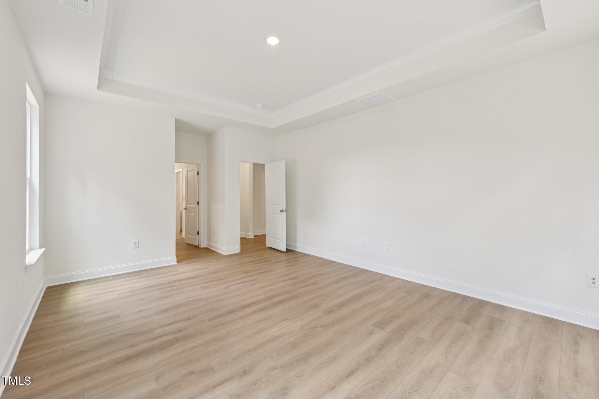 214 Alden Way Angier, NC 27501 - Photo 18 of 35 a view of an empty room with wooden floor