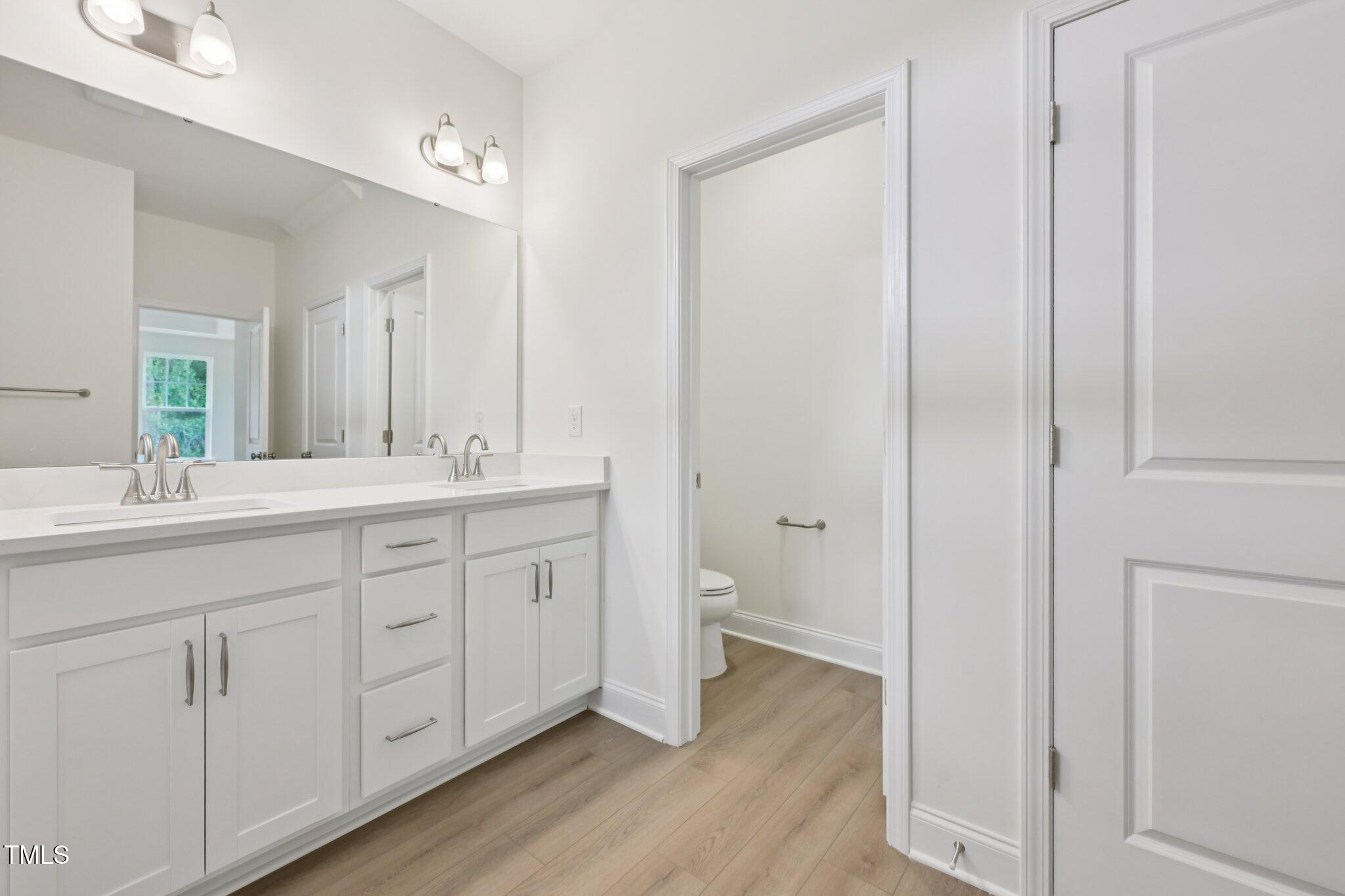 214 Alden Way Angier, NC 27501 - Photo 20 of 35 a bathroom with a double vanity sink and a mirror