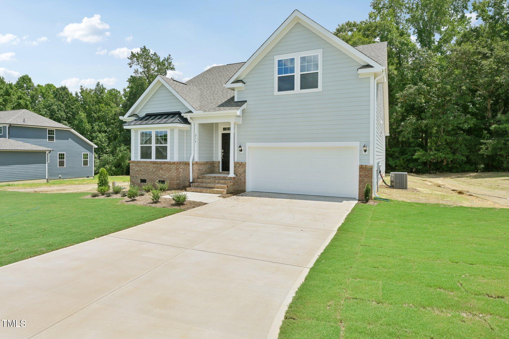 214 Alden Way Angier, NC 27501 - Photo 2 of 35 a front view of a house with garden