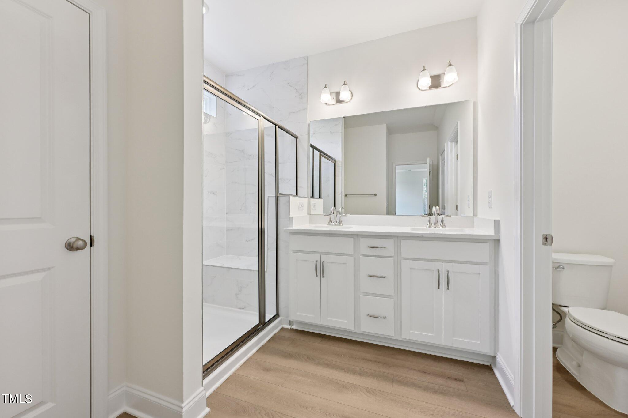 214 Alden Way Angier, NC 27501 - Photo 22 of 35 a bathroom with a double vanity sink and mirror