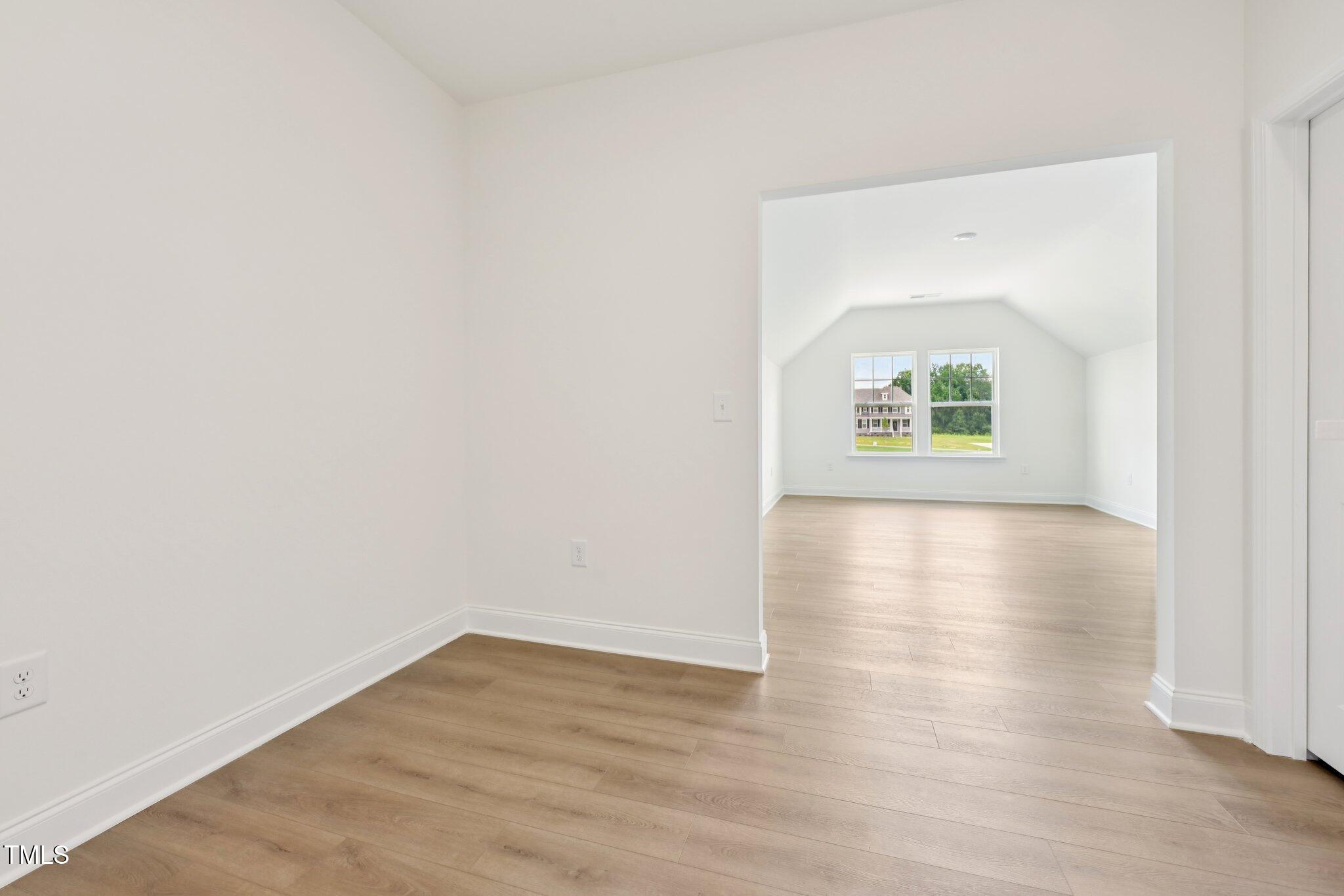 214 Alden Way Angier, NC 27501 - Photo 23 of 35 an empty room with wooden floor and a window