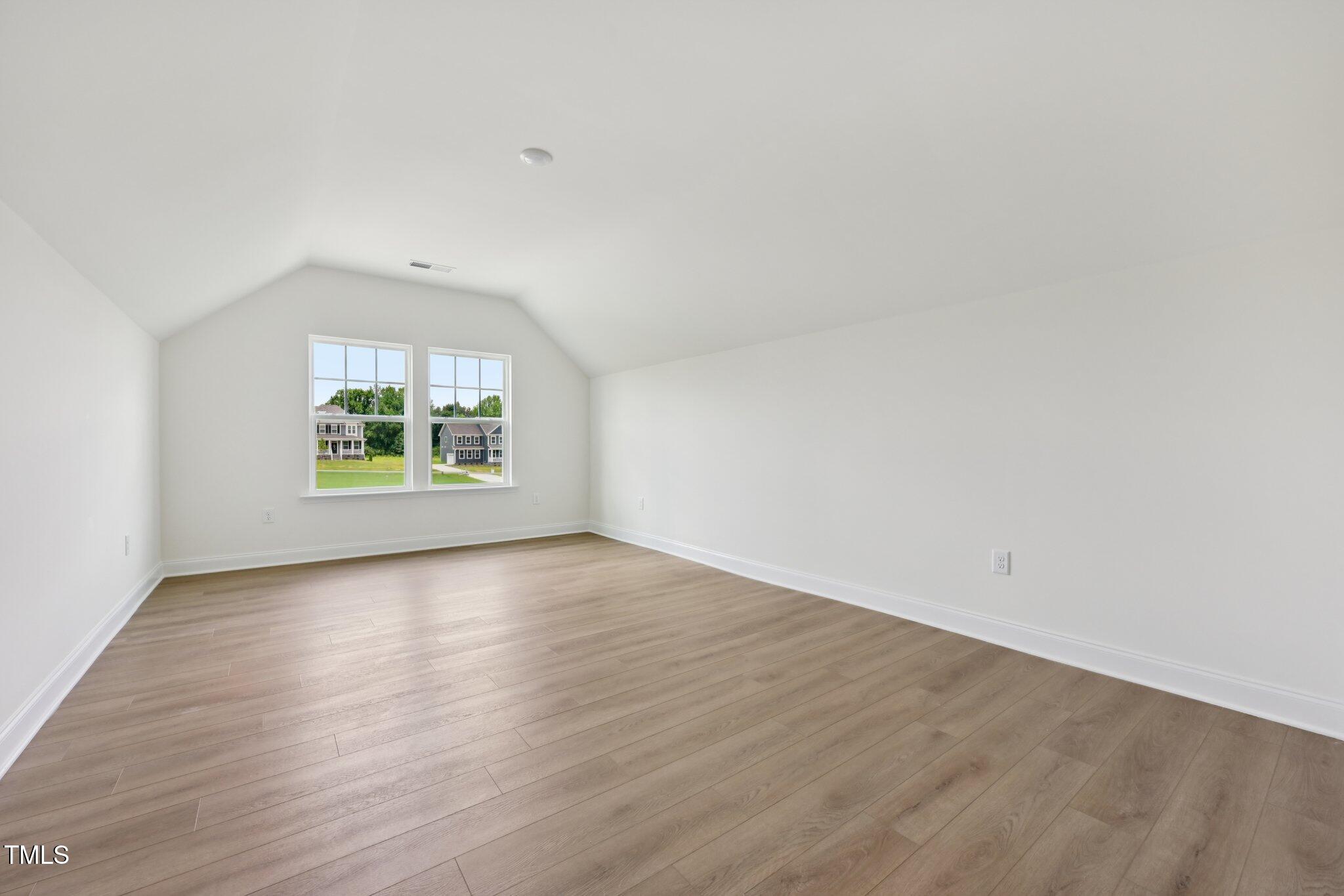214 Alden Way Angier, NC 27501 - Photo 25 of 35 an empty room with wooden floor and windows