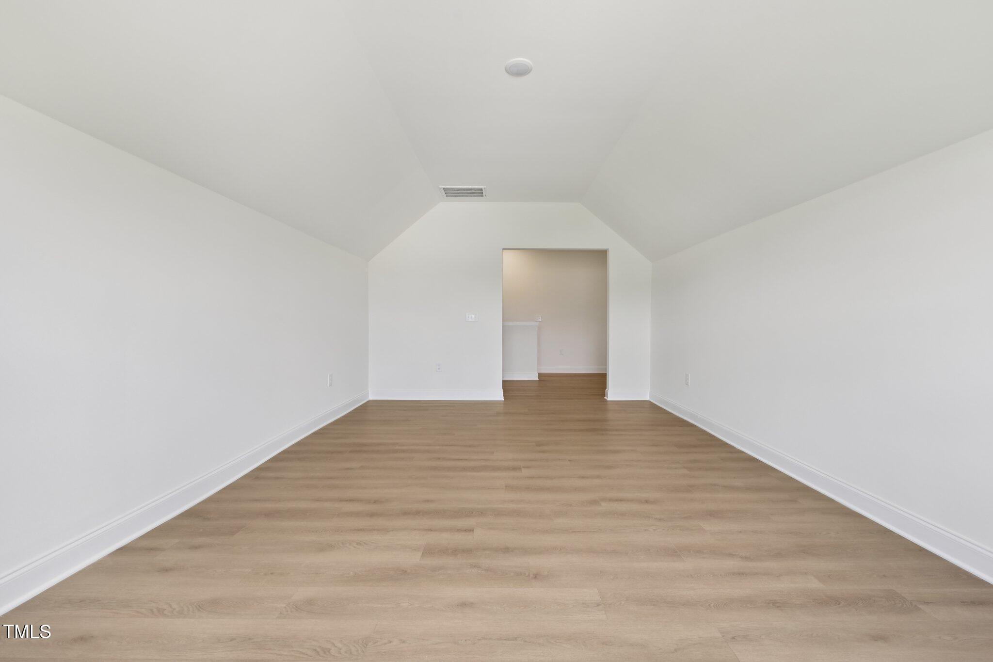 214 Alden Way Angier, NC 27501 - Photo 26 of 35 a view of empty room with wooden floor