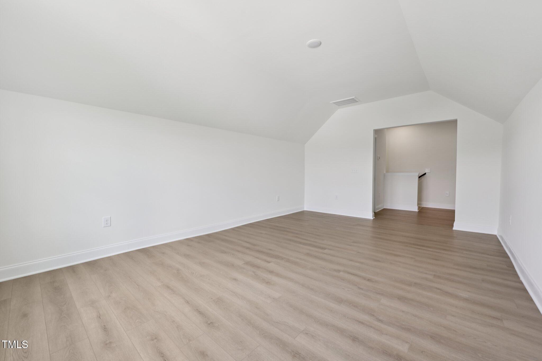 214 Alden Way Angier, NC 27501 - Photo 27 of 35 a view of empty room with wooden floor
